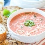 Crockpot Tomato Basil Soup in a bowl with bread on the side
