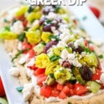 Greek Dip with Layers on a platter and topped with feta cheese.