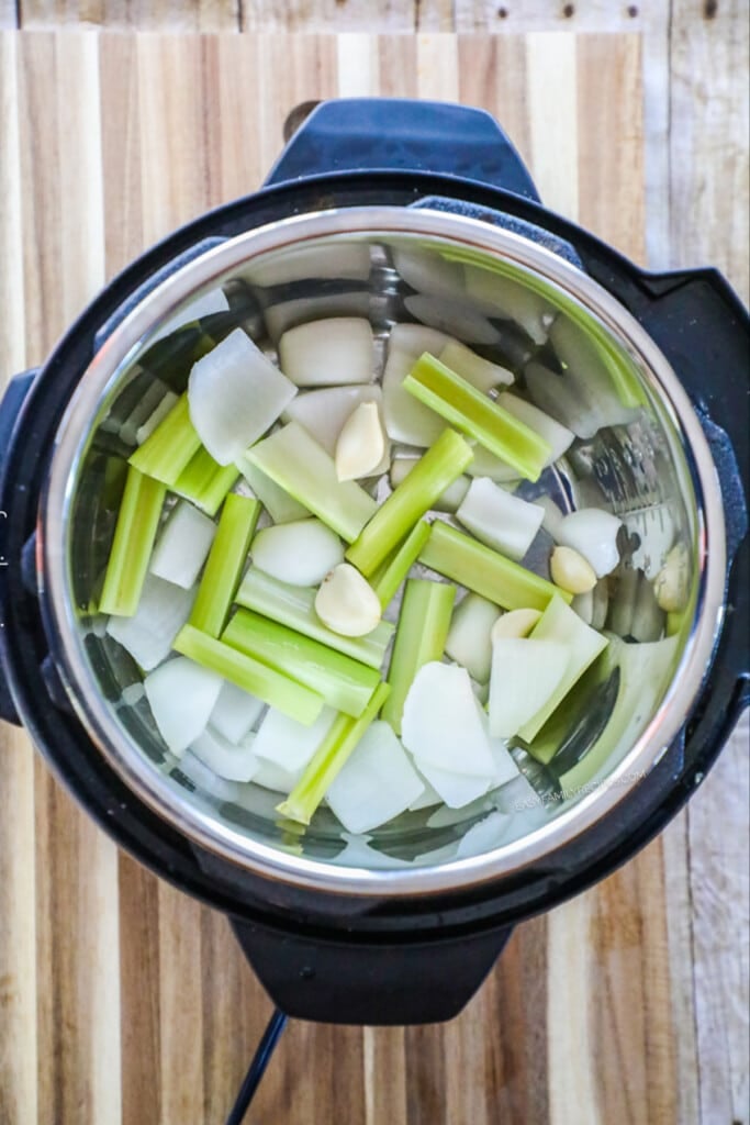 How to Make Turkey Breast in the pressure cooker step 1: Cut up celery and carrots and place in the bottom of the pressure cooker.