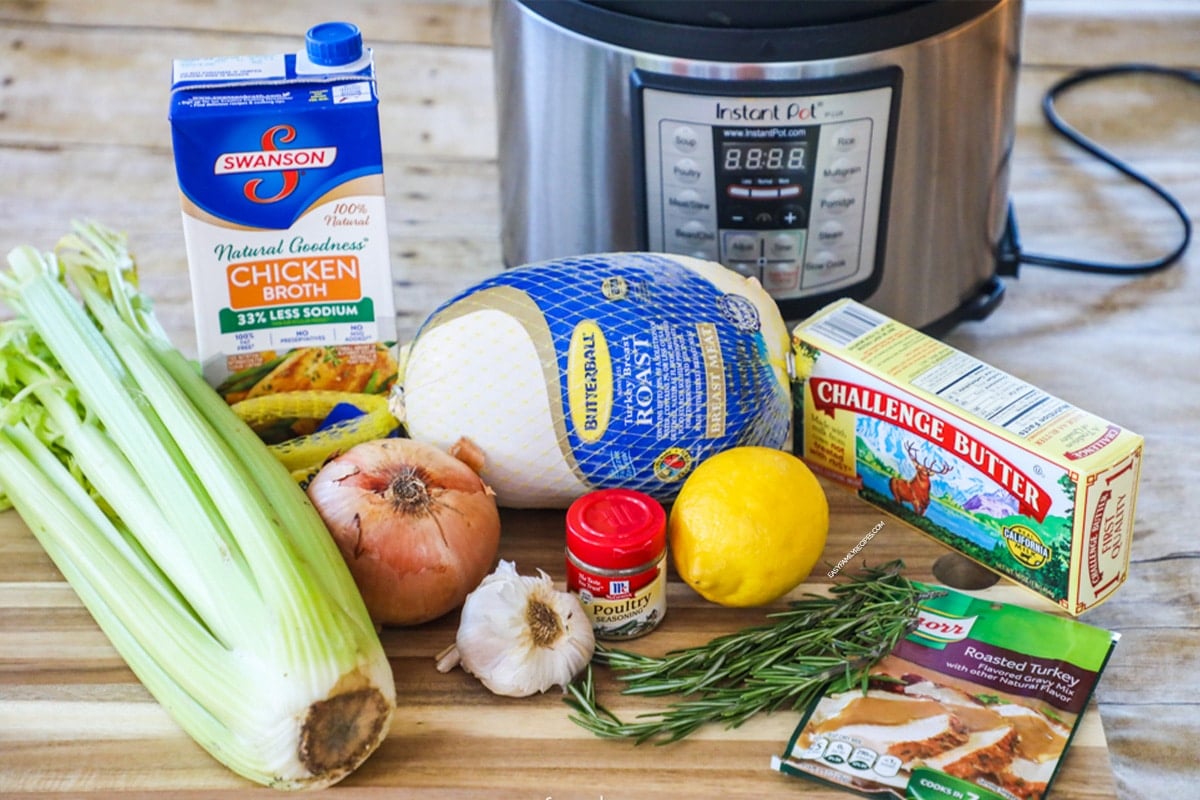 Ingredients for making pressure cooker turkey breast including butterball turkey breast, onion, celery, fresh herbs, butter, poultry seasoning.