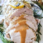 Sliced turkey breast with gravy running down the sides.