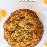 Overhead shot of a cornflake cookie with golden brown edges and a soft center.