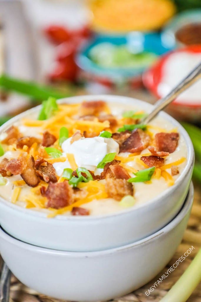 How to make crockpot baked potato soup step 4: Top with sour cream, bacon, cheese, and chives.