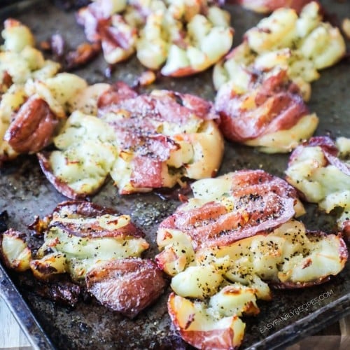 Garlic Smashed Potatoes with golden crispy edges on baking sheet