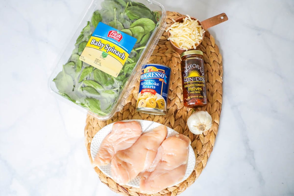 Ingredients to make Tuscan Garlic Chicken - spinach, chicken, artichokes, cheese, garlic and sundried tomatoes