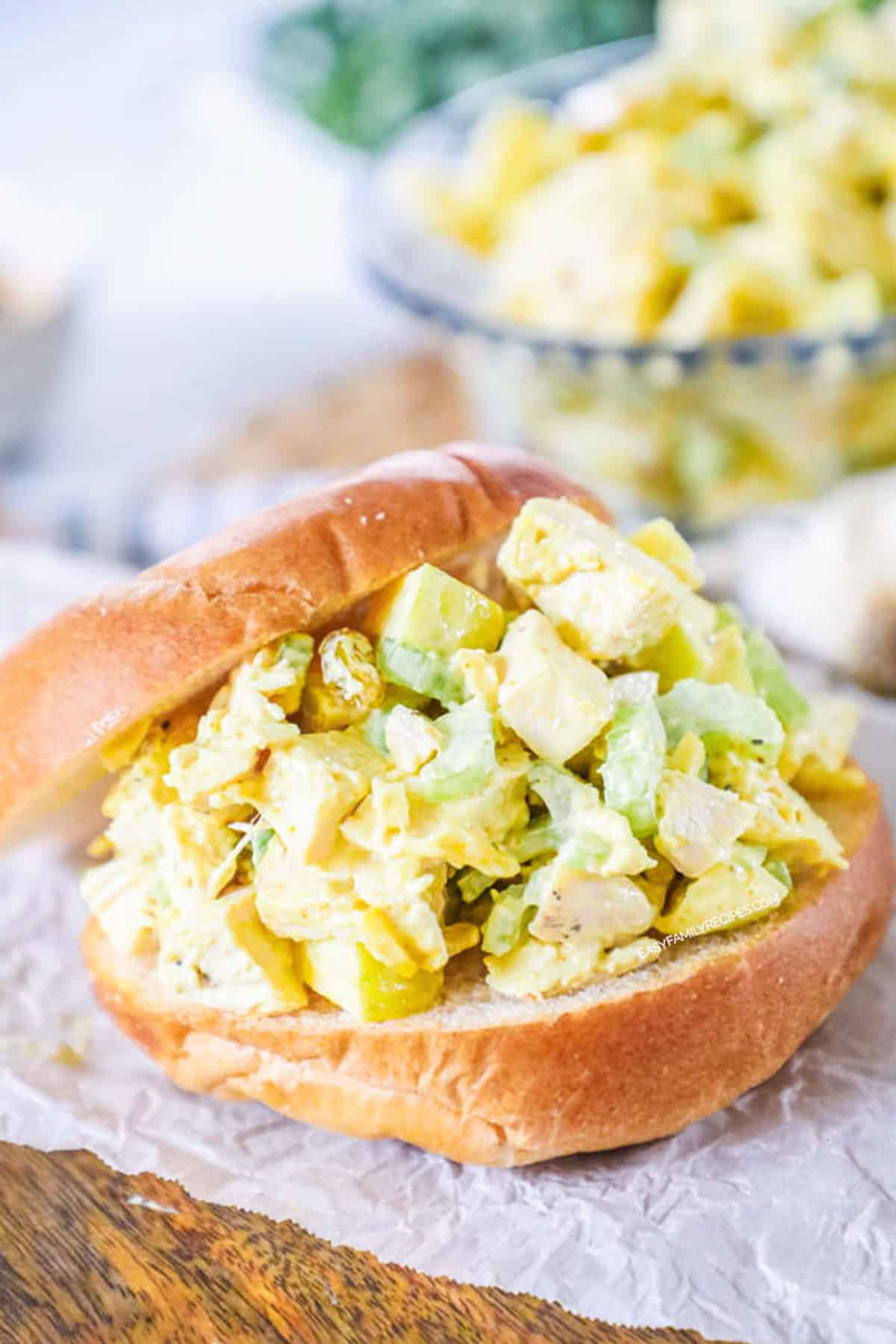 Curry chicken salad served on a bakery bun.