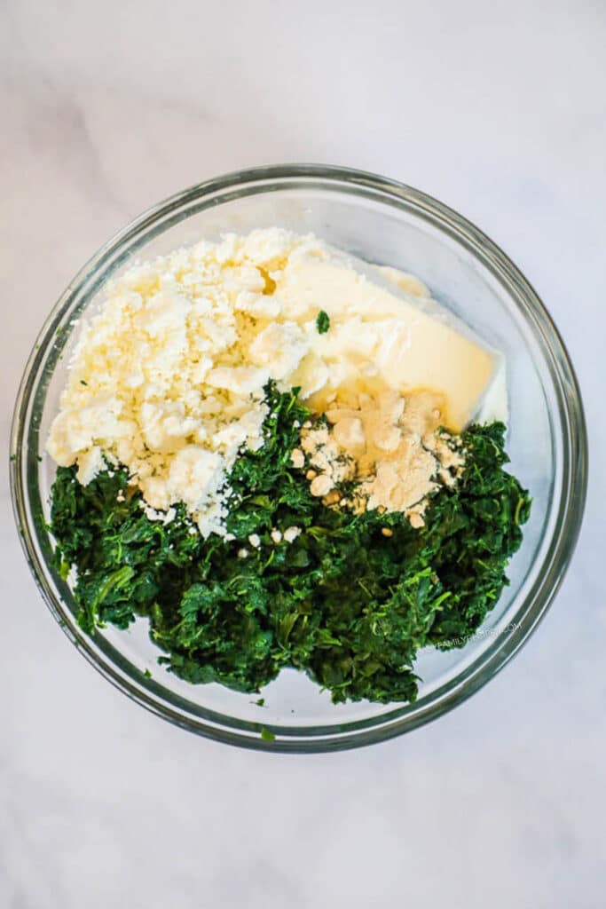 How to make Spinach and Feta Chicken Step 1: Combine spinach with cheeses and spices.