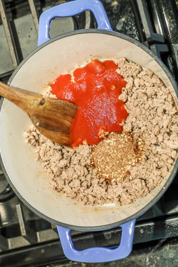 How to Make Taco Stuffed Zucchini Boats Step 2: Combine Ground Turkey with taco seasoning and tomato sauce.