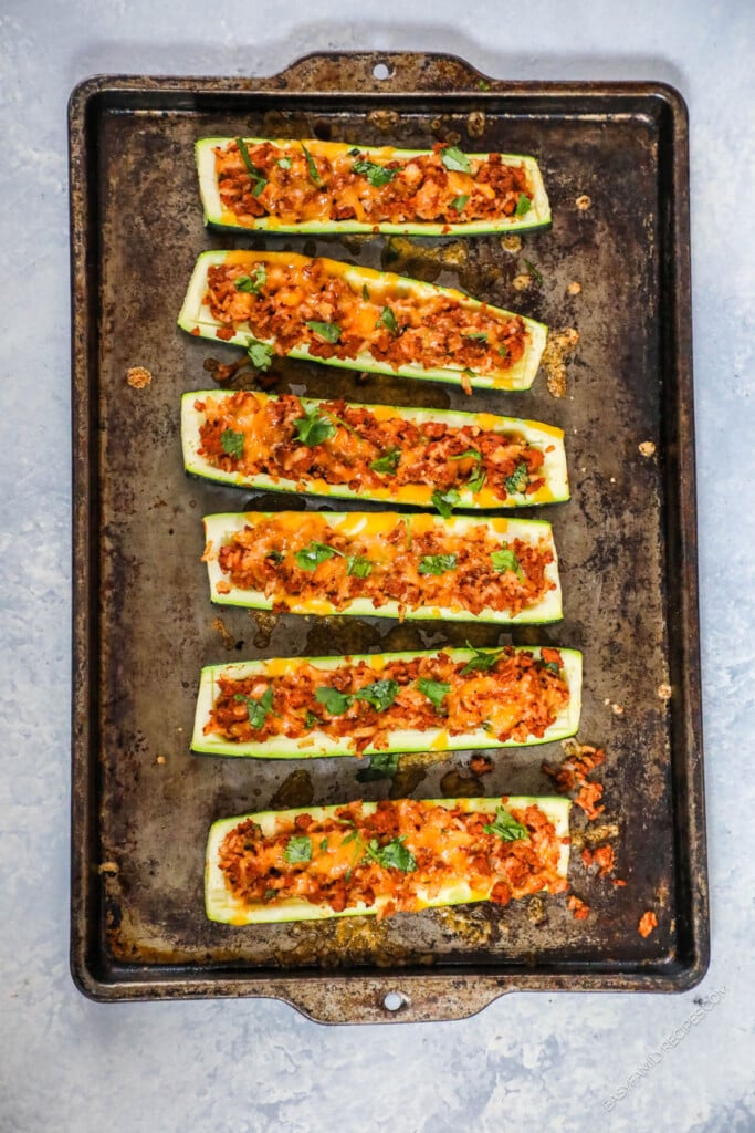 How to Make Taco Stuffed Zucchini Boats Step 4: Add the taco meat mixture to the hollowed zucchini and top with cheese. Bake until tender.