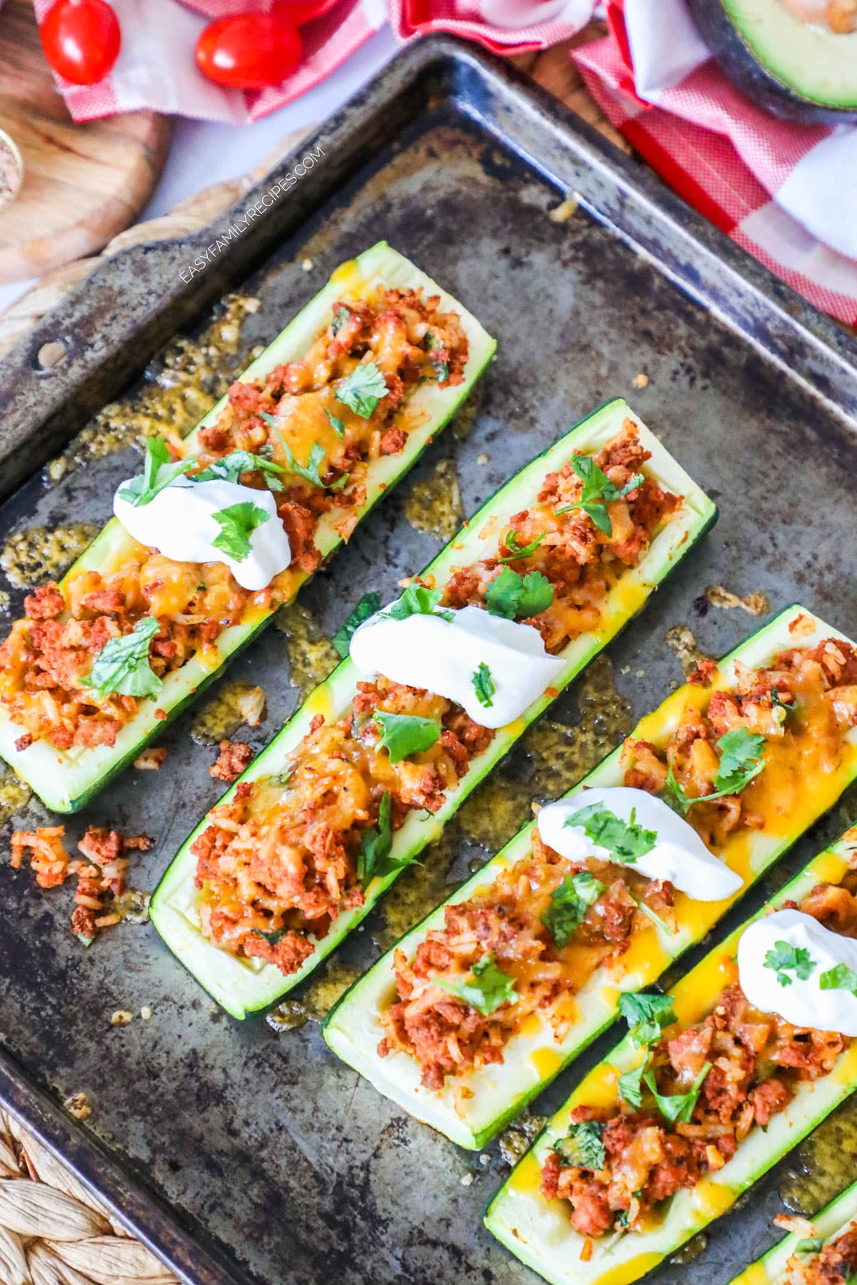 Taco stuffed zucchini boats on baking sheet.