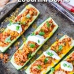 Zucchini boats stuffed with taco meat and topped with cheese and sour cream.