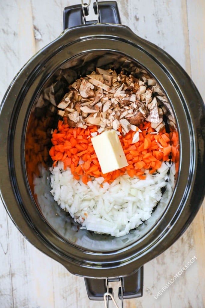 How to make creamy chicken wild rice soup in crockpot. Step 1: Place onion, carrot, mushrooms and butter in the crockpot