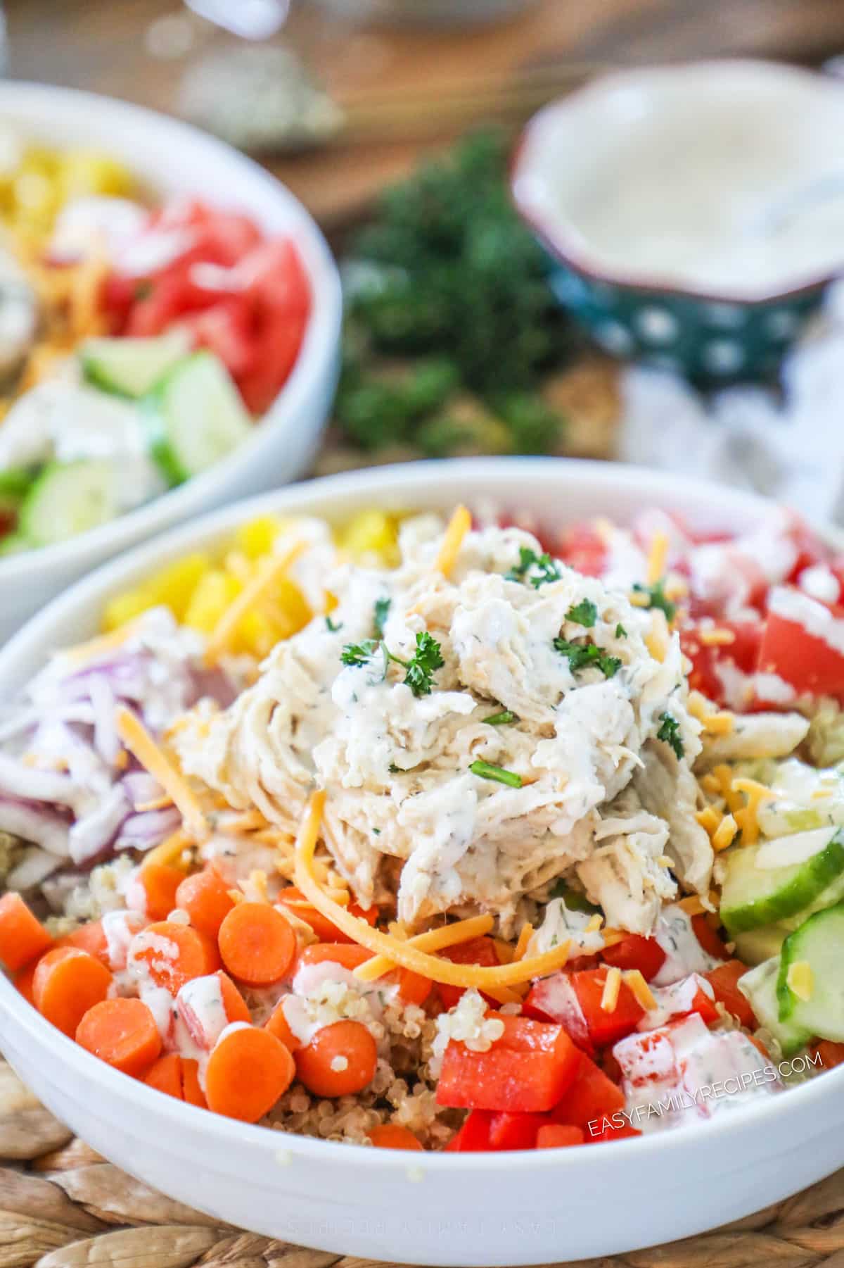 Creamy Ranch Chicken made in the slow cooker piled on top of a colorful salad