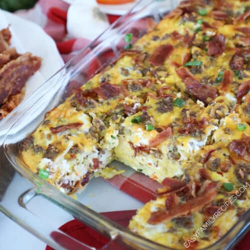 Breakfast sausage and hashbrown casserole in a baking dish being scooped out