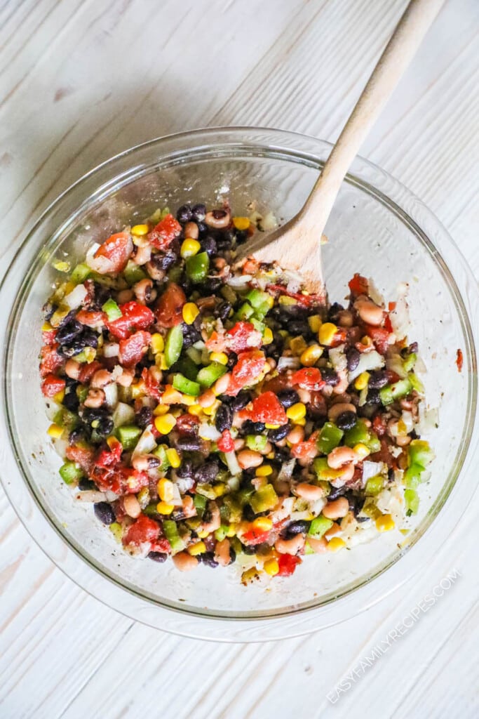 How to Make Cowboy Chicken Step 2: Prepare cowboy caviar topping and mix to combine.