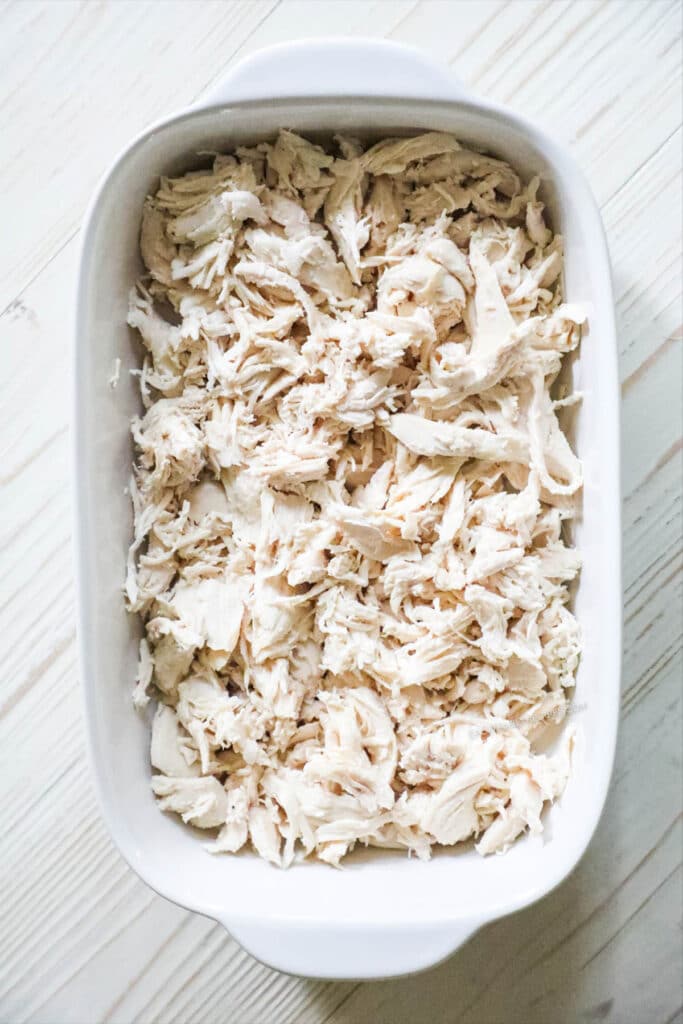 How to make BBQ Chicken Casserole Step 1: Shred chicken and add to casserole dish.