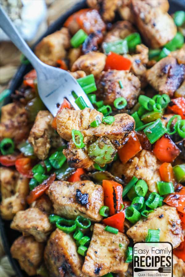 Fork taking a bite of cajun chicken