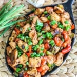 Cajun Chicken in skillet garnished with green onions