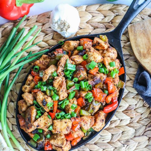 Cajun Chicken in skillet garnished with green onions