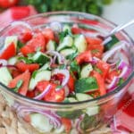 Classic cucumber tomato salad with red onions as a side dish
