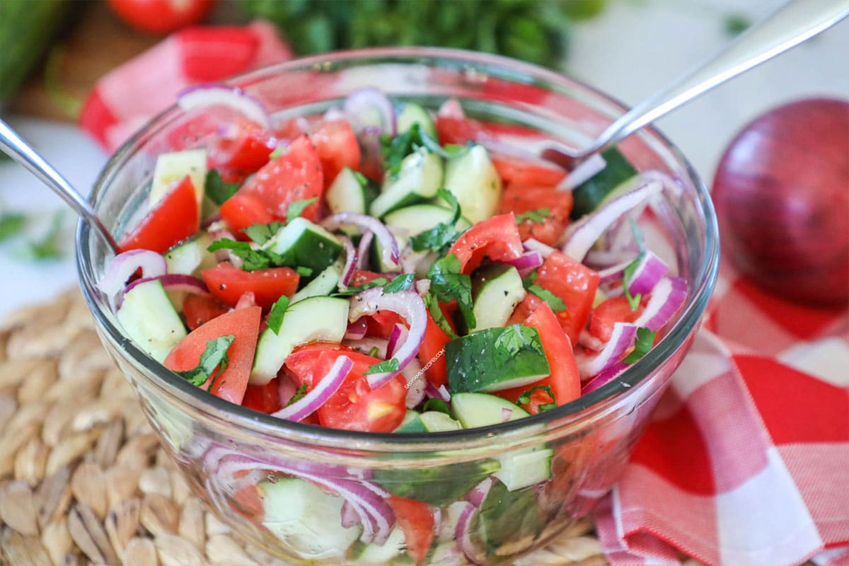 Classic cucumber tomato salad with red onions as a side dish