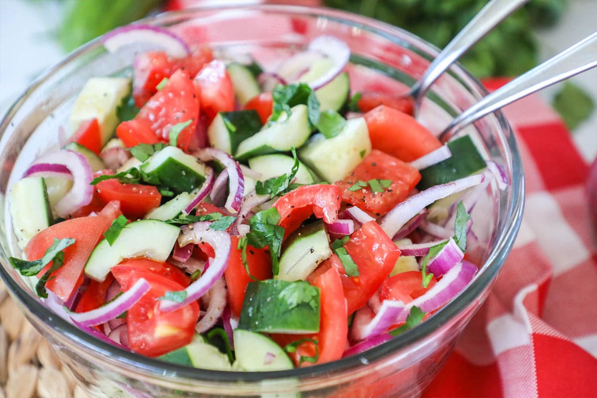 Classic cucumber tomato salad with red onions as a side dish