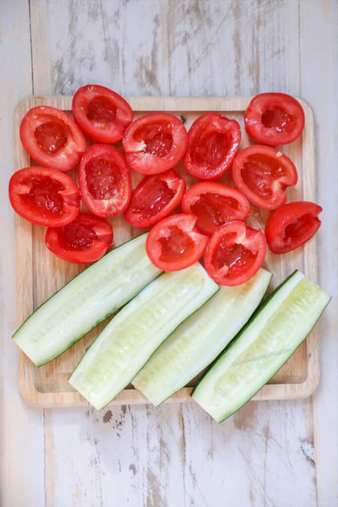 Step 1 - Cut the cucumbers and tomatoes in half and remove the seeds.
