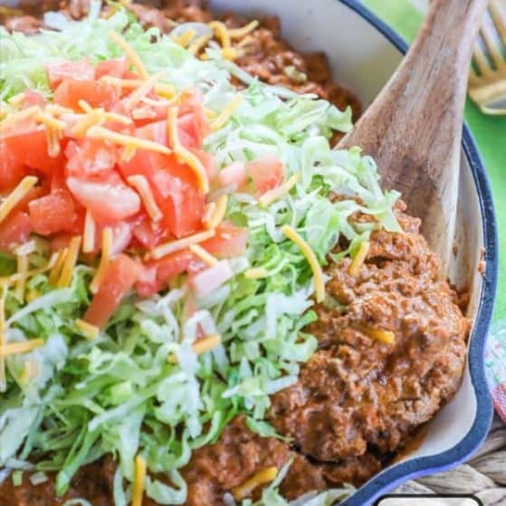 Easy Cheesy Taco Skillet topped with lettuce and tomatoes
