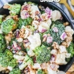 Bowl of broccoli cauliflower salad ready to serve for potluck.