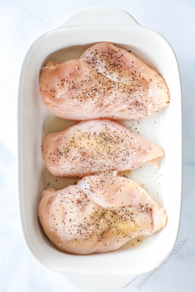 How to Make Baked Caesar Chicken Step 1: Season chicken and place in baking dish.