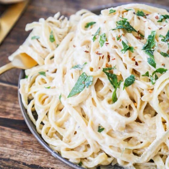 Homemade Pasta Sauce made with Cream Cheese tossed with pasta and topped with parsley and red pepper