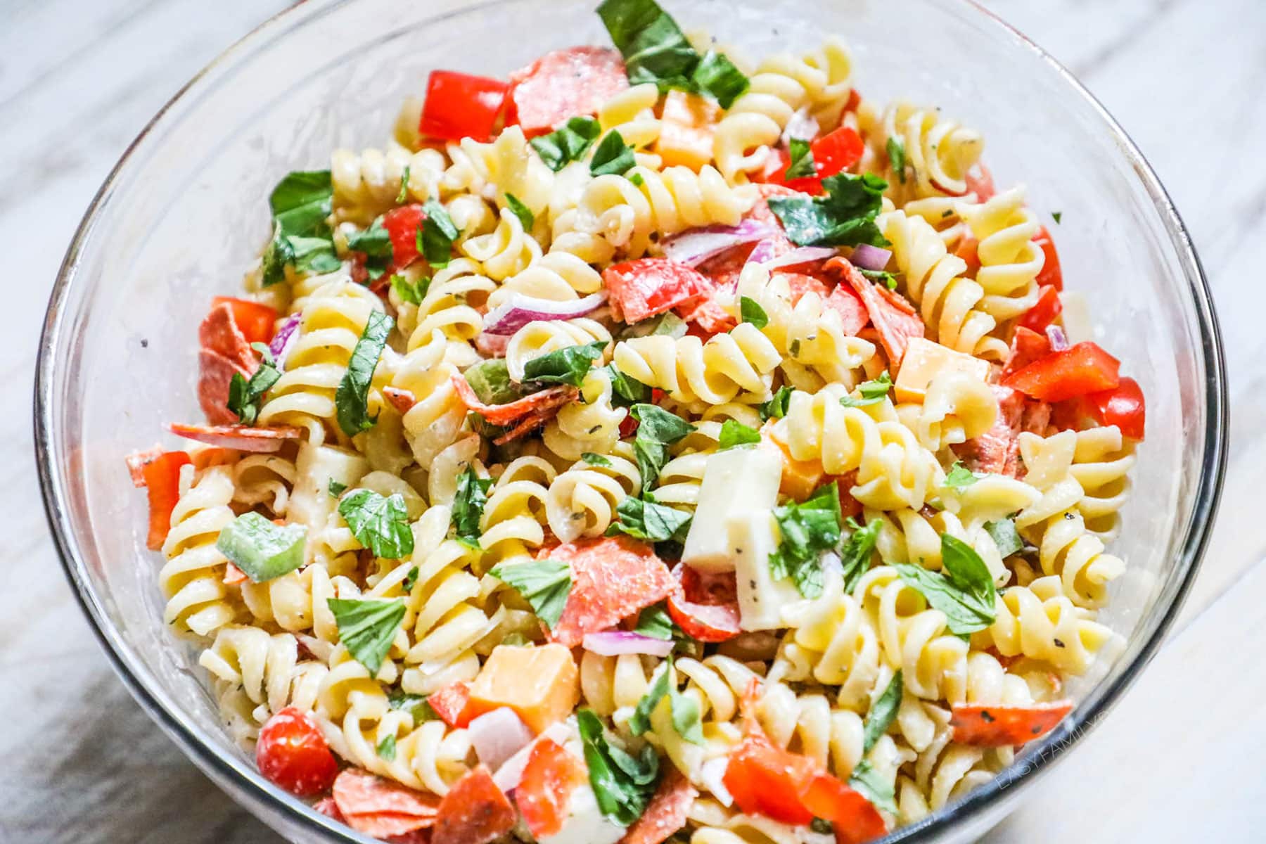 Rotini Salad with pepperoni, cheeses, and veggies in a bowl