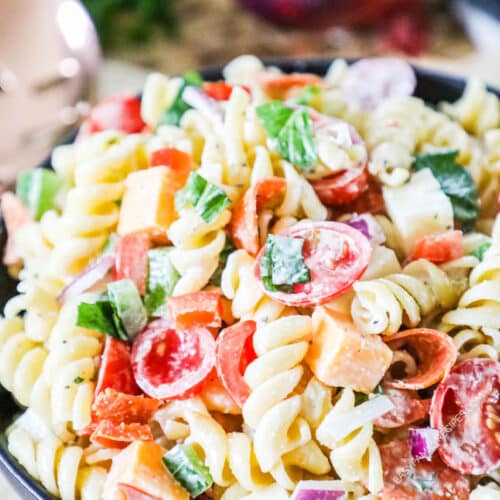 Rotini Salad with pepperoni, cheeses, and veggies in a bowl