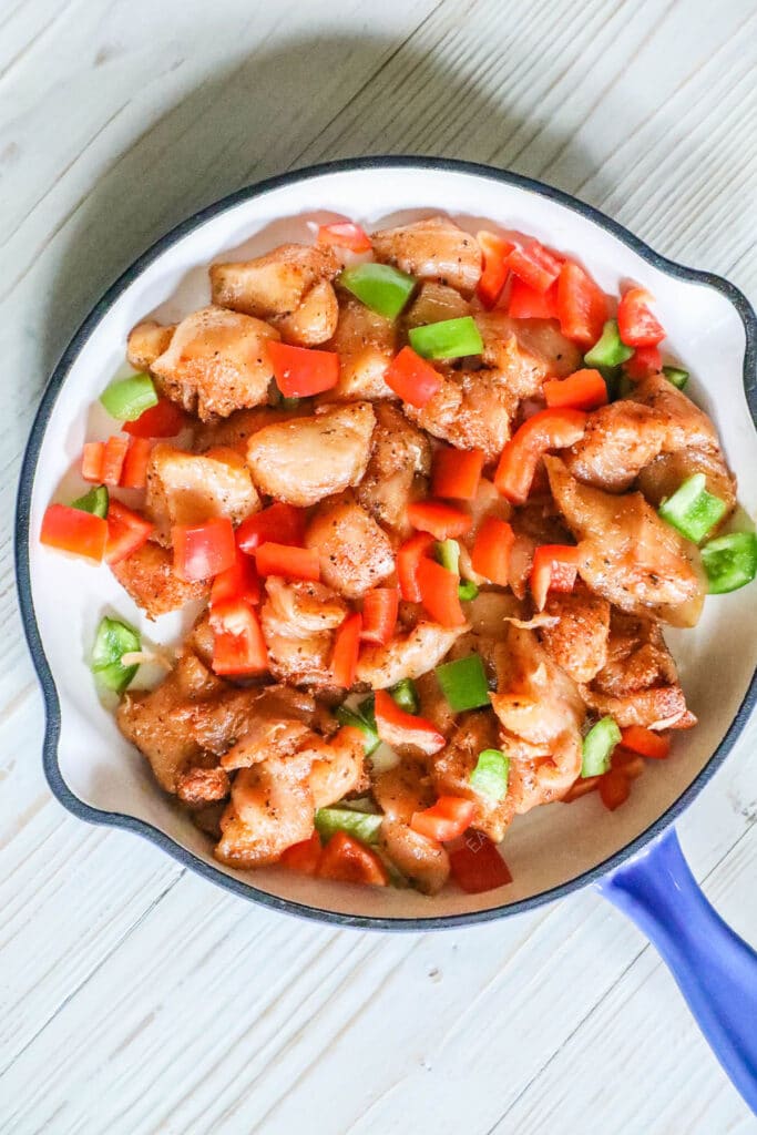 How to make Cajun Chicken Pasta Step 2: Add marinated chicken to skillet with bell peppers and let it brown.