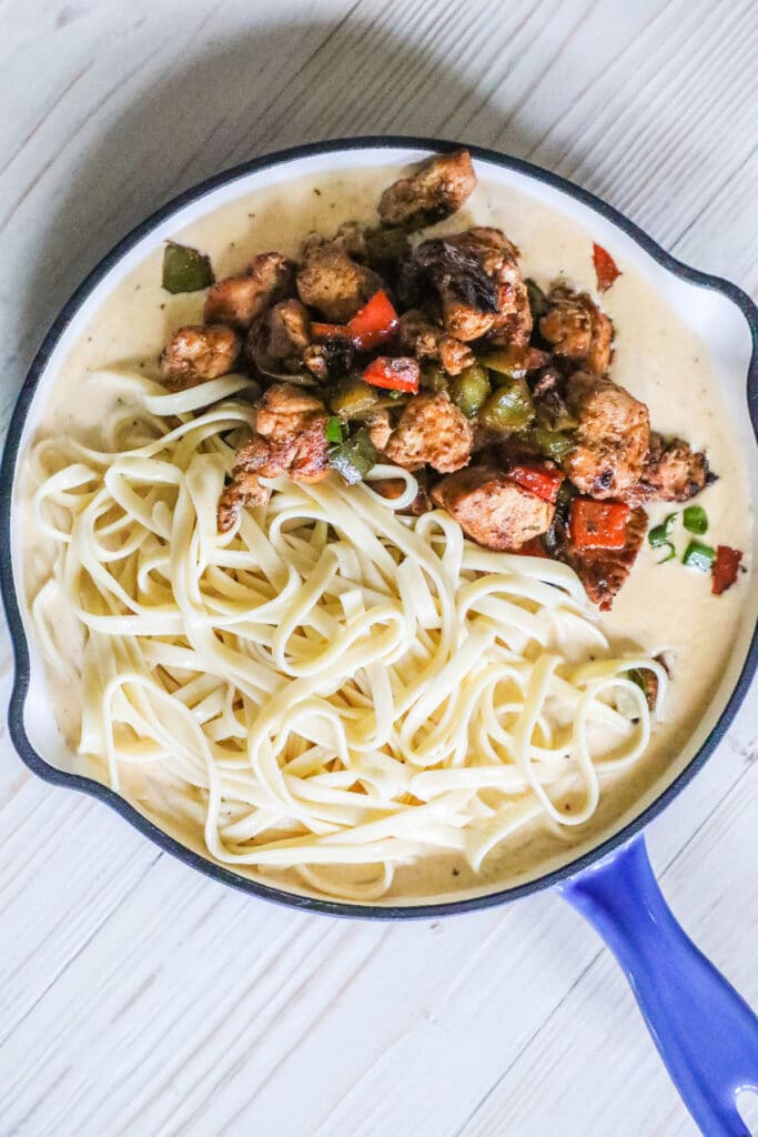 How to make Cajun Chicken Pasta Step 4: Add the chicken, peppers, and pasta back into the sauce.