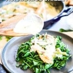 chicken and asparagus with cream sauce served over spinach
