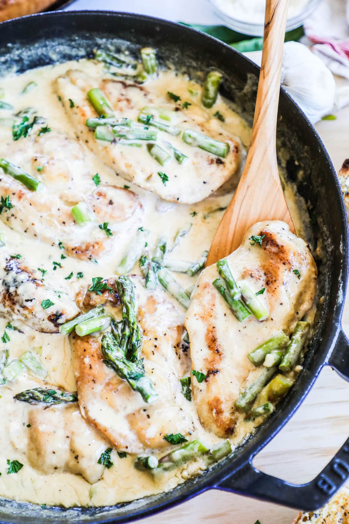 Close up of chicken breast in chicken and asparagus skillet
