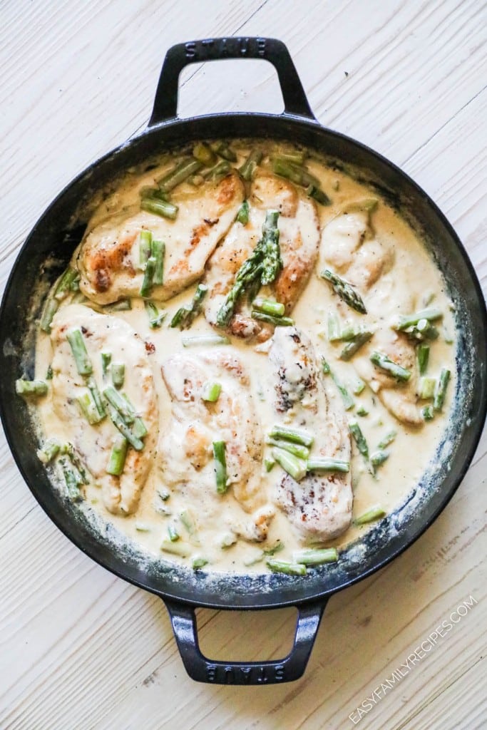 How to make chicken and asparagus: Step 4- once the sauce is thickened, add the chicken breast back in with the asparagus cream sauce and simmer to done.