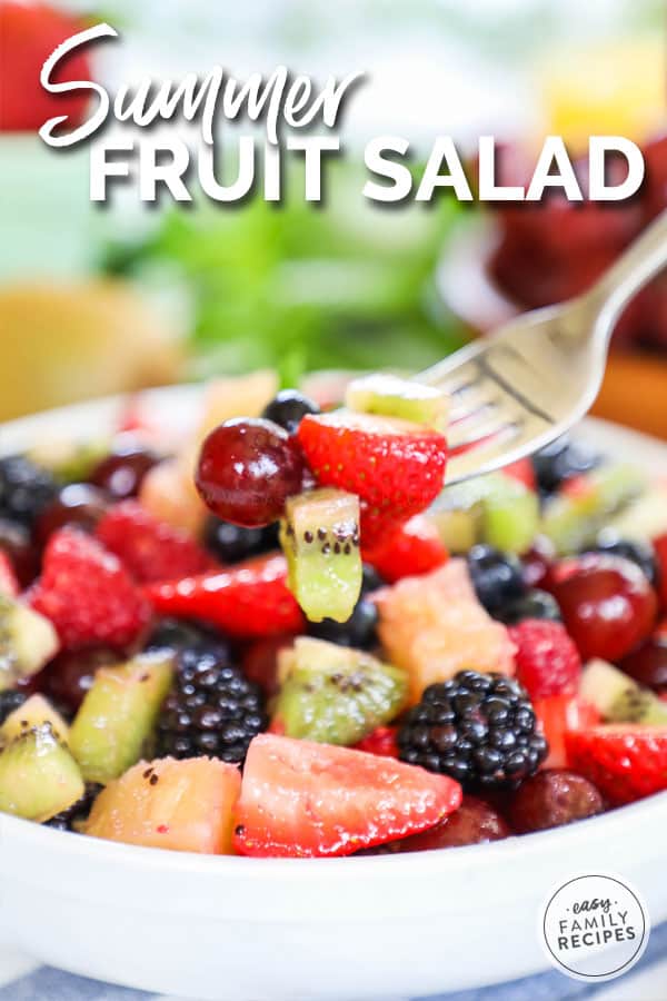 Fruit Salad on fork tossed with fruit salad dressing
