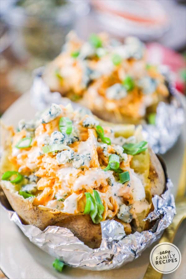 Baked Potatoes Stuffed with Buffalo Chicken and drizzled with blue cheese