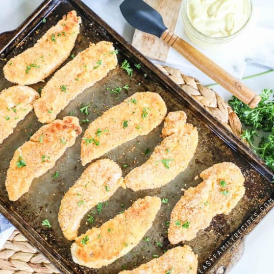 Healthy Chicken Tenders on a baking sheet just out of the oven
