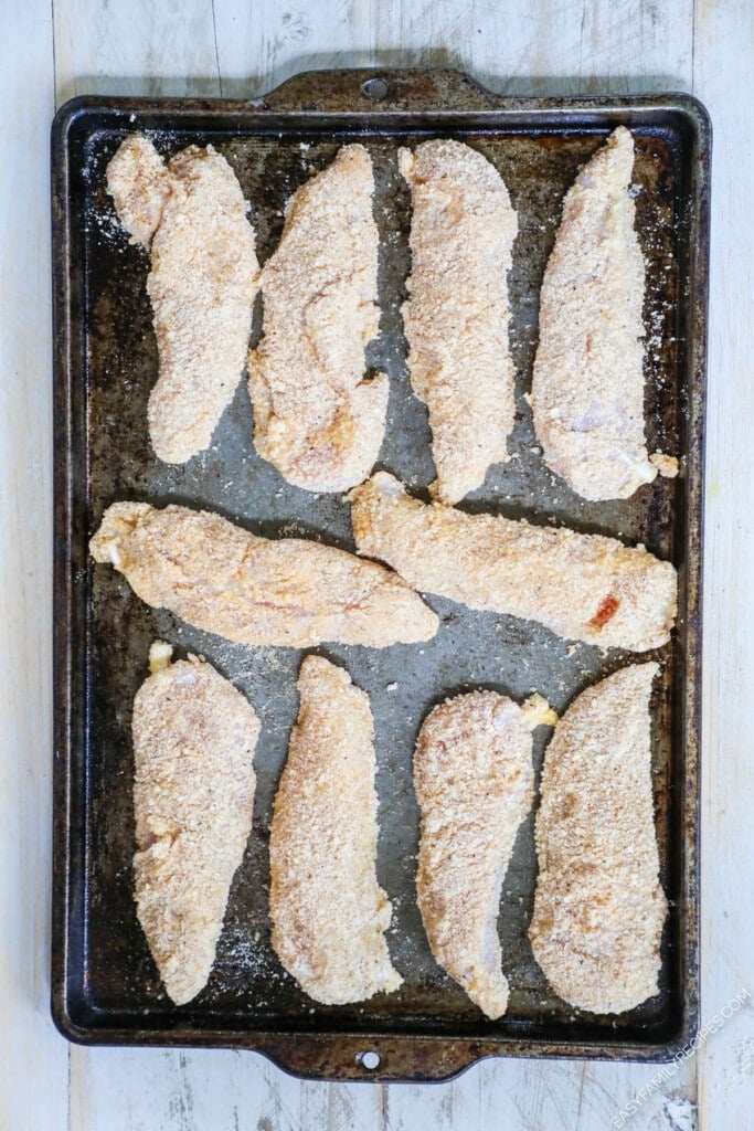 How to make crispy chicken tenders in the oven Step 4: Lay on a greased baking sheet in a single layer.
