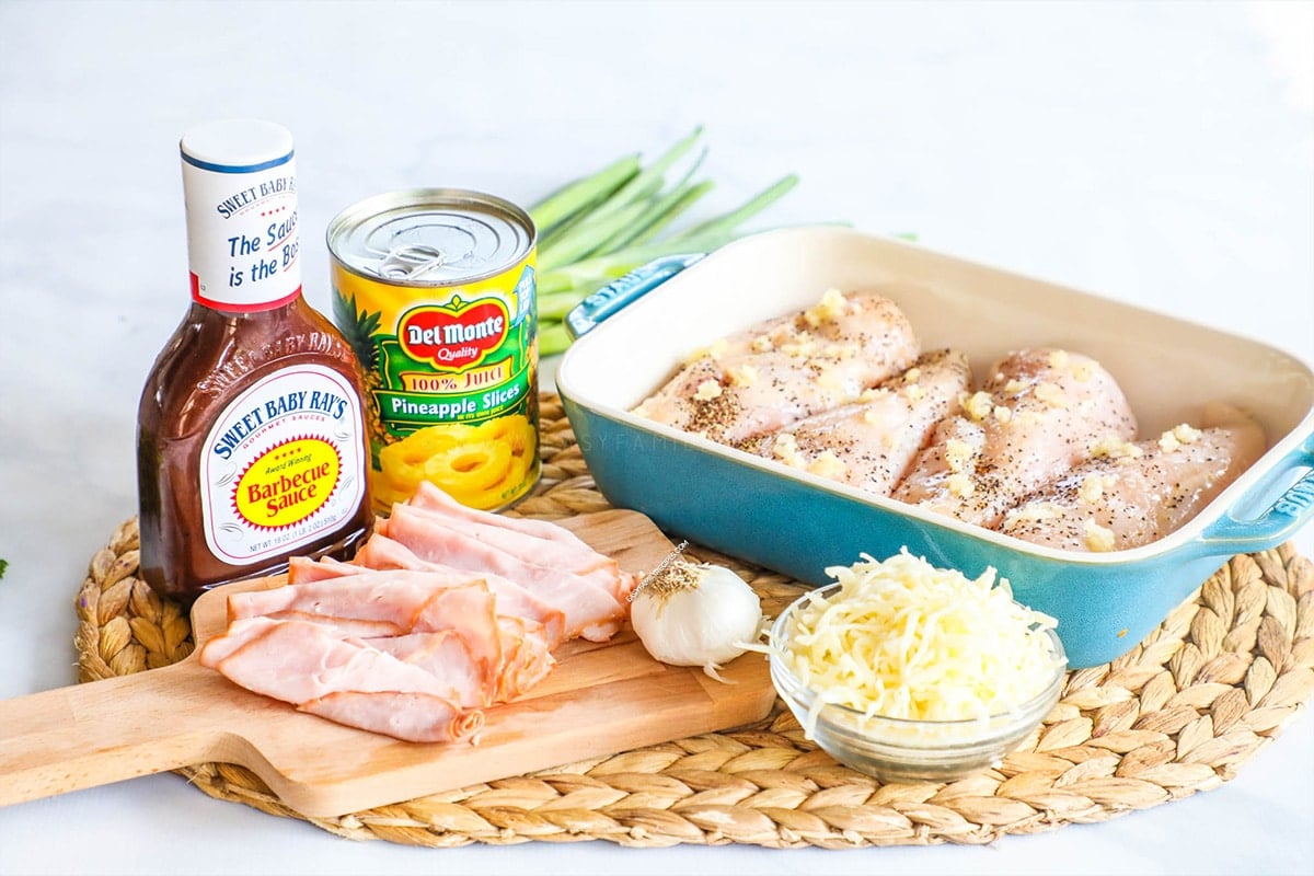 Ingredients for baked Hawaiian Chicken recipe: BBQ sauce, chicken breast, pineapples, seasonings, ham and cheese