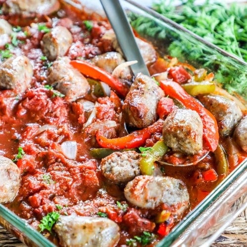 Baked Italian Sausage and Peppers recipe being spooned out of dish