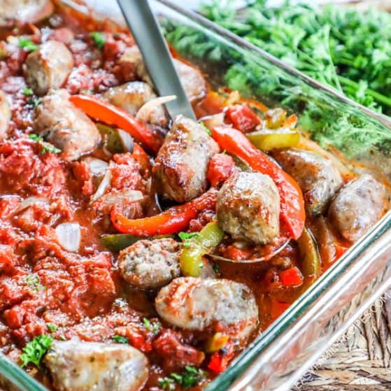 Baked Italian Sausage and Peppers recipe being spooned out of dish