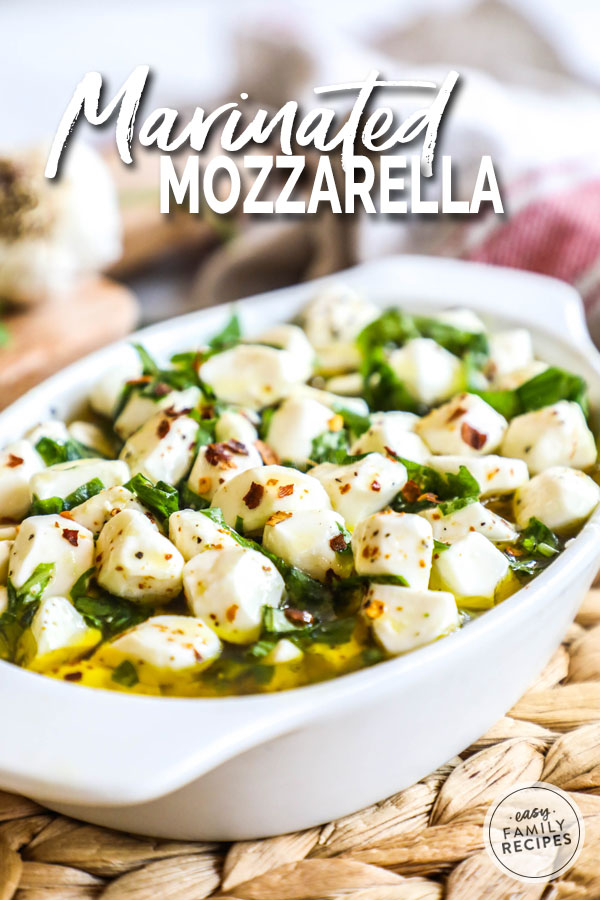 Mozzarella Marinating in olive oil, herbs, and spices in a dish