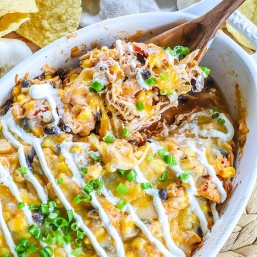 Shredded chicken Mexican Chicken Casserole being served out of a baking dish