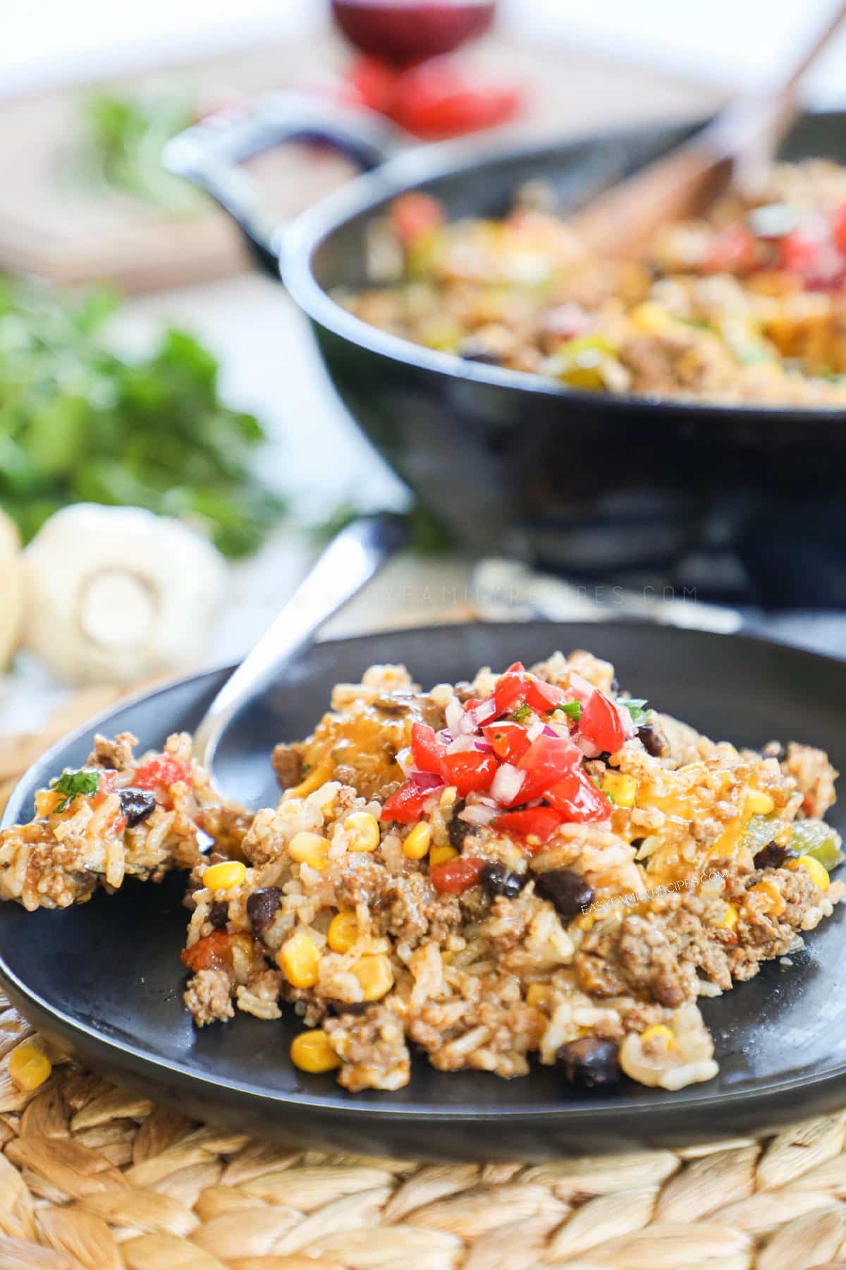 Mexican Ground Beef and Rice casserole on a plate topped with salsa and ready for an easy dinner.