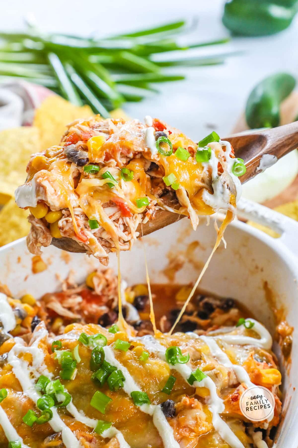 Scooping Mexican Chicken Casserole out of casserole dish