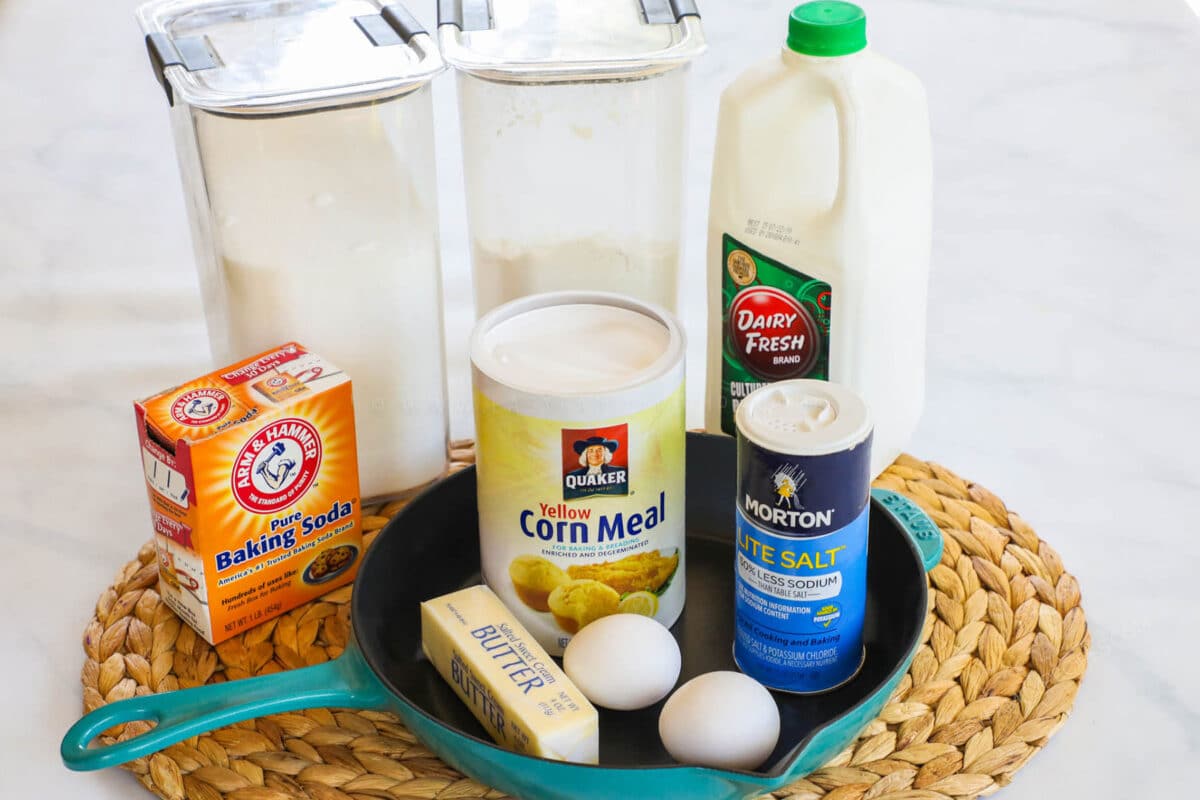 Ingredients to make cornbread - flour, sugar, baking soda, salt, cornmeal, eggs, butter and buttermilk